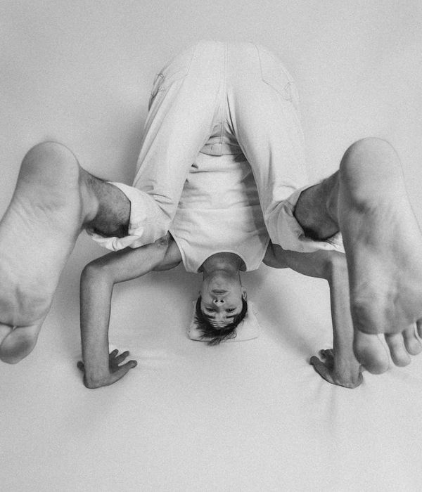 Man performing a controlled strength exercise in a calm studio environment.